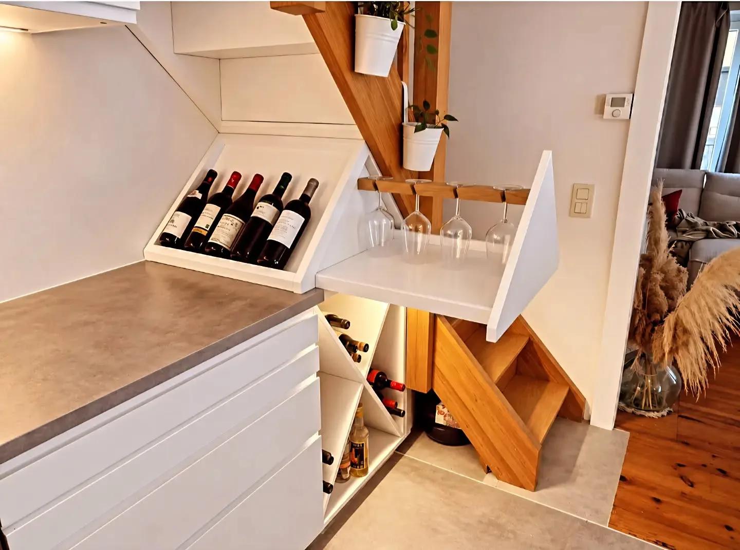 Bottle compartments and glass rack under the stairs